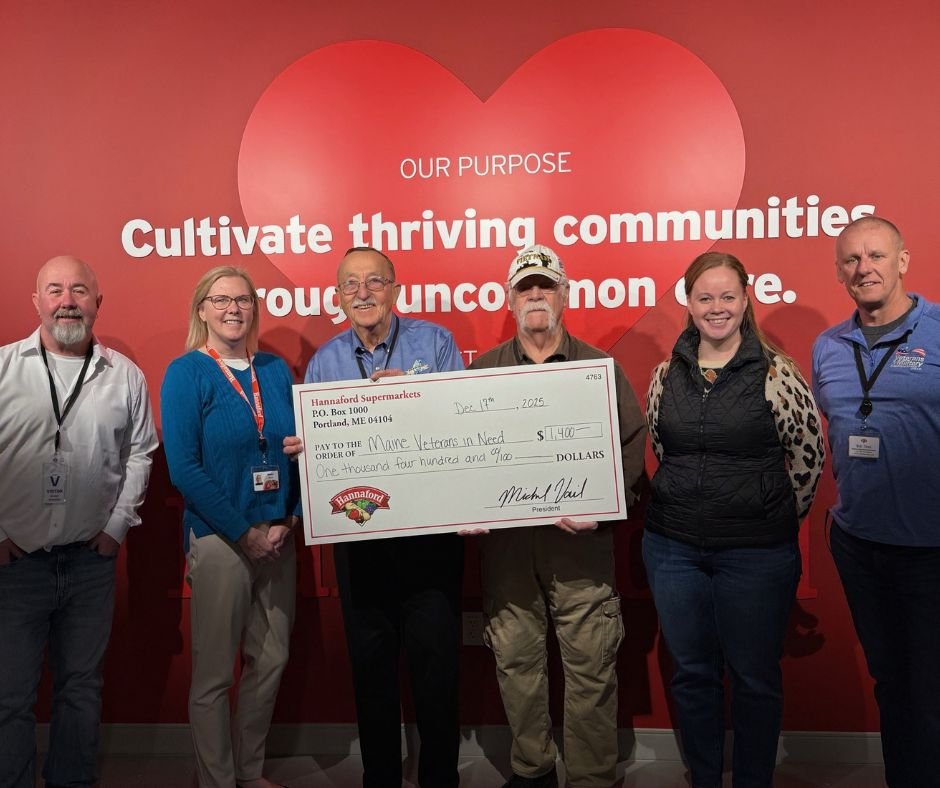 Hannaford Staff present a large domation check to MVN